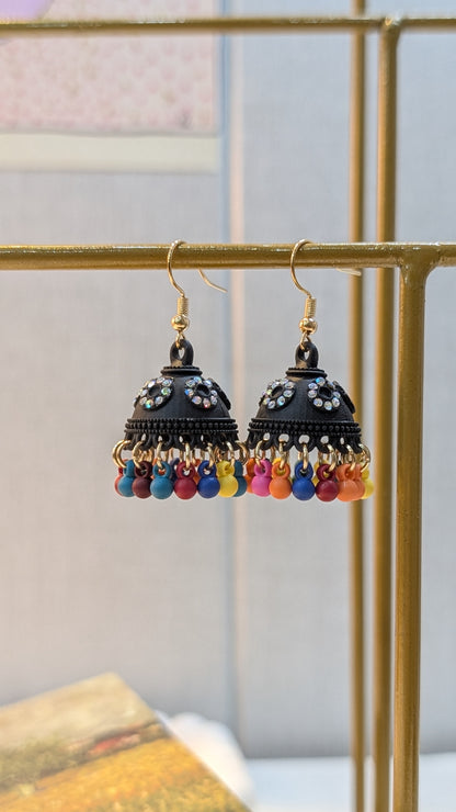 Pair of black dome-shaped dangle earrings with gold-tone hooks, clear circular accents, and a fringe of small colorful beads.